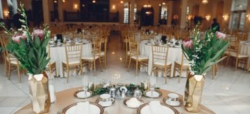 Beautiful wedding decor. Golden dishes in a wedding table